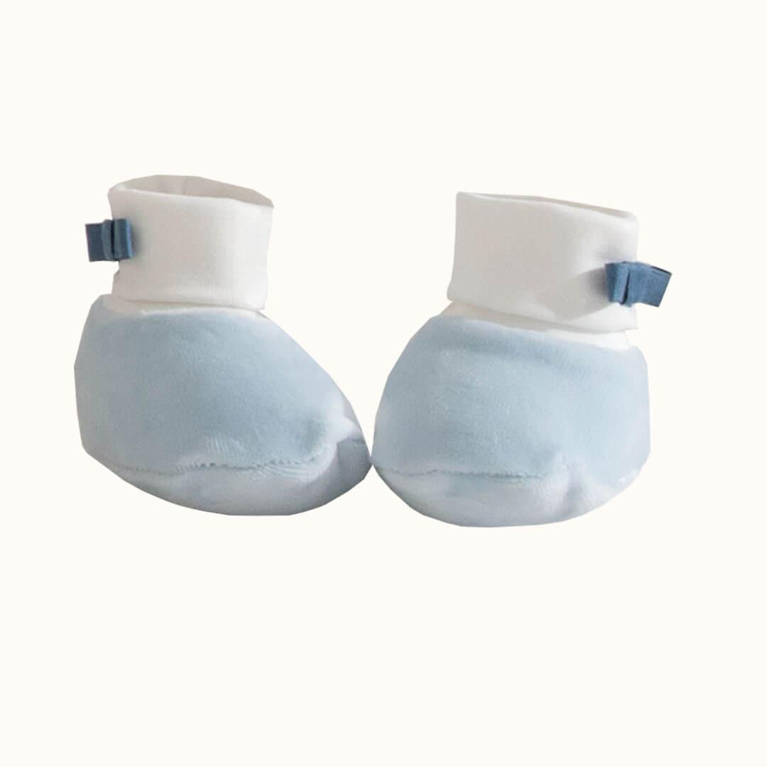 pantufas de bebé azul claro com detalhe de laço em tecido macio, ideais para recém-nascidos
