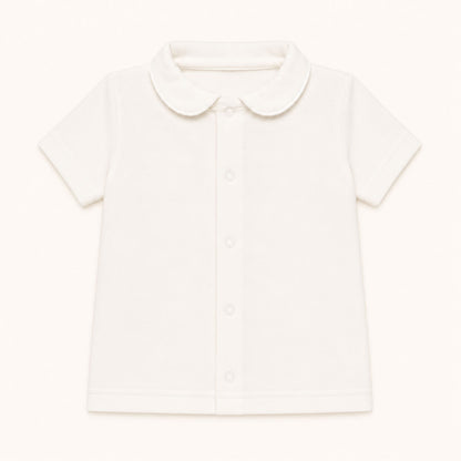 camisola com gola redonda em malha algodão bege, ideal para bebés de 12 meses aos 48 meses, no verão. Sem etiquetas irritantes no decote e abrir de cima a baixo para facilitar a muda da roupa.