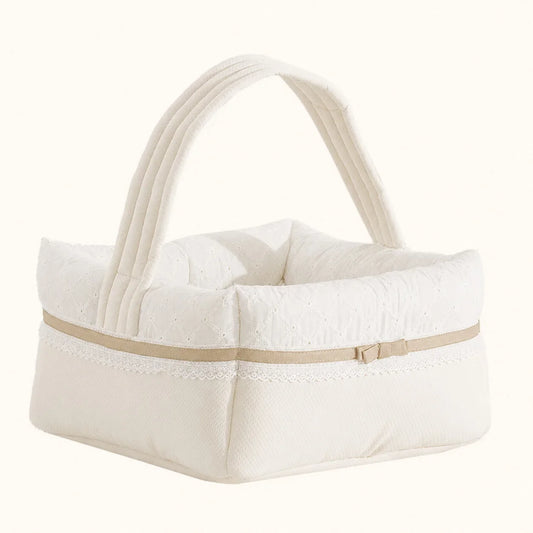 Cesta de enxoval para bebé em tecido bege com detalhes em renda e alça acolchoada