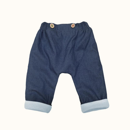 Calças de bebé em denim azul com punhos dobrados e cós elástico, roupa confortável infantil.